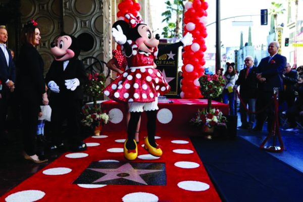 The character of Minnie Mouse poses on her star after it was unveiled on the Hollywood Walk of Fame in Los Angeles