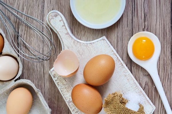 Fresh Farm Eggs On A Wooden Rustic Background. Separated Egg Whi