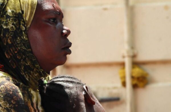 A Sudanese refugee holds her child at the Gorom Refugee camp hosting Sudanese refugees near Juba
